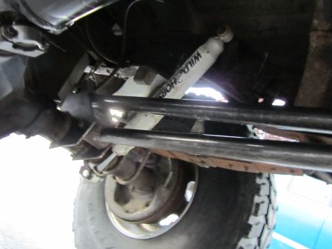 1984 Ford Bronco - Close-up view of the undercarriage, highlighting a shock absorber with visible branding.