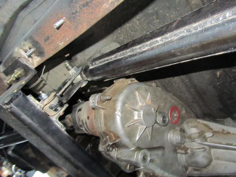 1984 Ford Bronco - Close-up of the vehicle's transfer case and driveshaft, showing modifications and welding.
