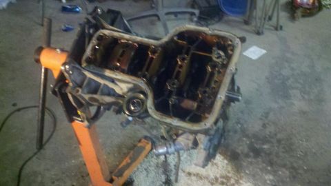 2006 Ford E350 - Engine block on an engine stand, showing internal components with oil residue.