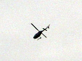 1999 Ford Crown Victoria - A helicopter is seen in the sky, with its rotors in motion.