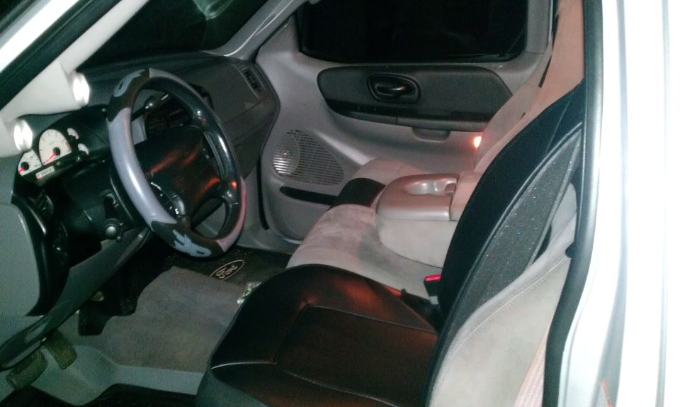 2002 Ford F-150 interior showing dashboard, steering wheel, and seats