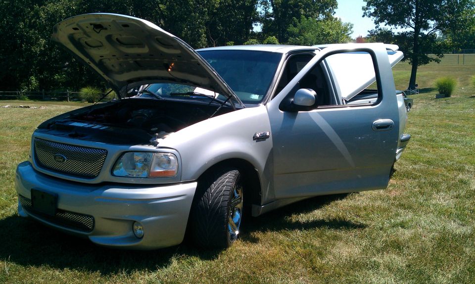 Silver 2002 Ford F-150 Lightning with hood and driver door open