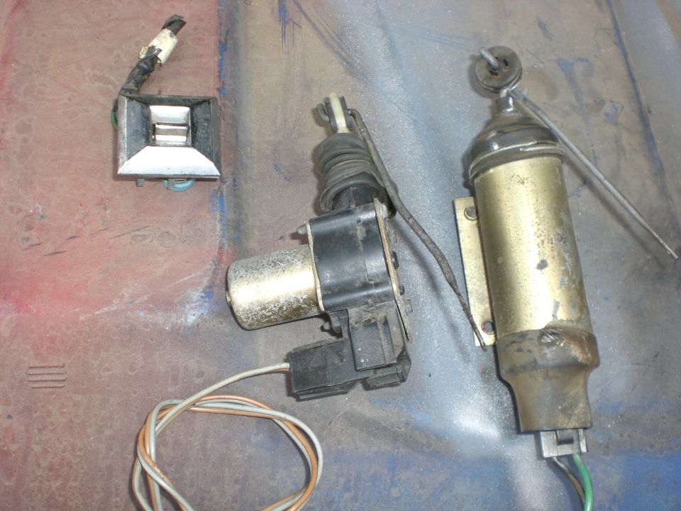 On the left is a random 70's GM window switch. Plenty in the yard. The center is a mid 70's and up door lock motor, the righ is a mid 70's and older door lock actuator. Either will work fine they just wire up differently.