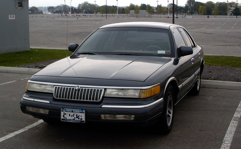 Dark gray Mercury Grand Marquis parked in an empty lot