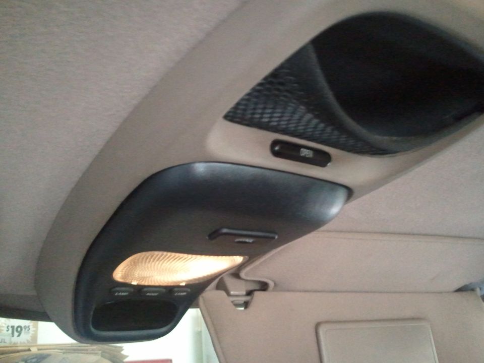 Overhead console with illuminated light, storage compartment, and 'OPEN' button