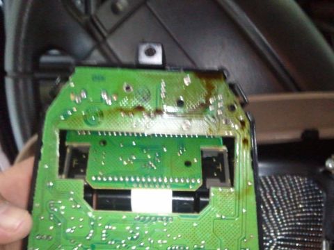 1994 Ford Bronco - A close-up view of a damaged electronic circuit board, likely from a vehicle's overhead console.