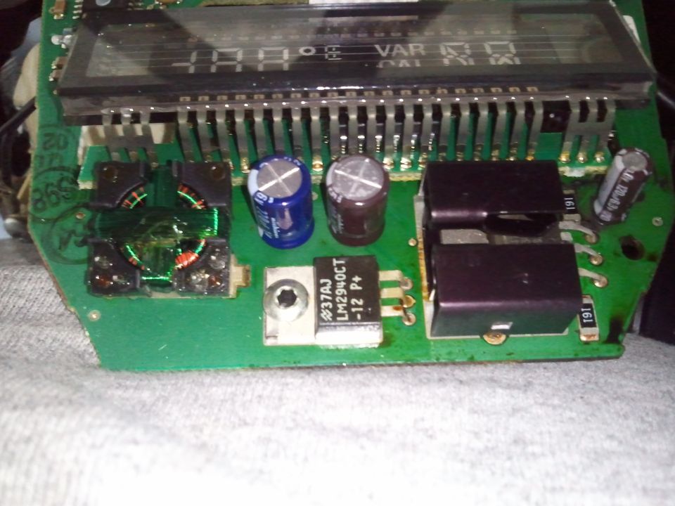 Circuit board with digital display showing '48.0', capacitors, and integrated circuits