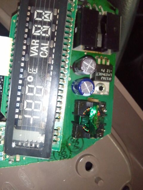1994 Ford Bronco - Close-up of a circuit board with a digital display and electronic components.
