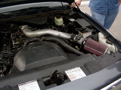 1999 Ford Crown Victoria - Engine bay of a gray Ford Crown Victoria, modified with an aftermarket air intake system.
