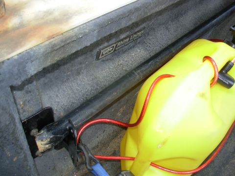 1997 Chevrolet Silverado 3500 - This simple bracket (an old battery tray brace from my Bronco) & a strap from the wheelwell to the stake pocket keep the digging bar from r…