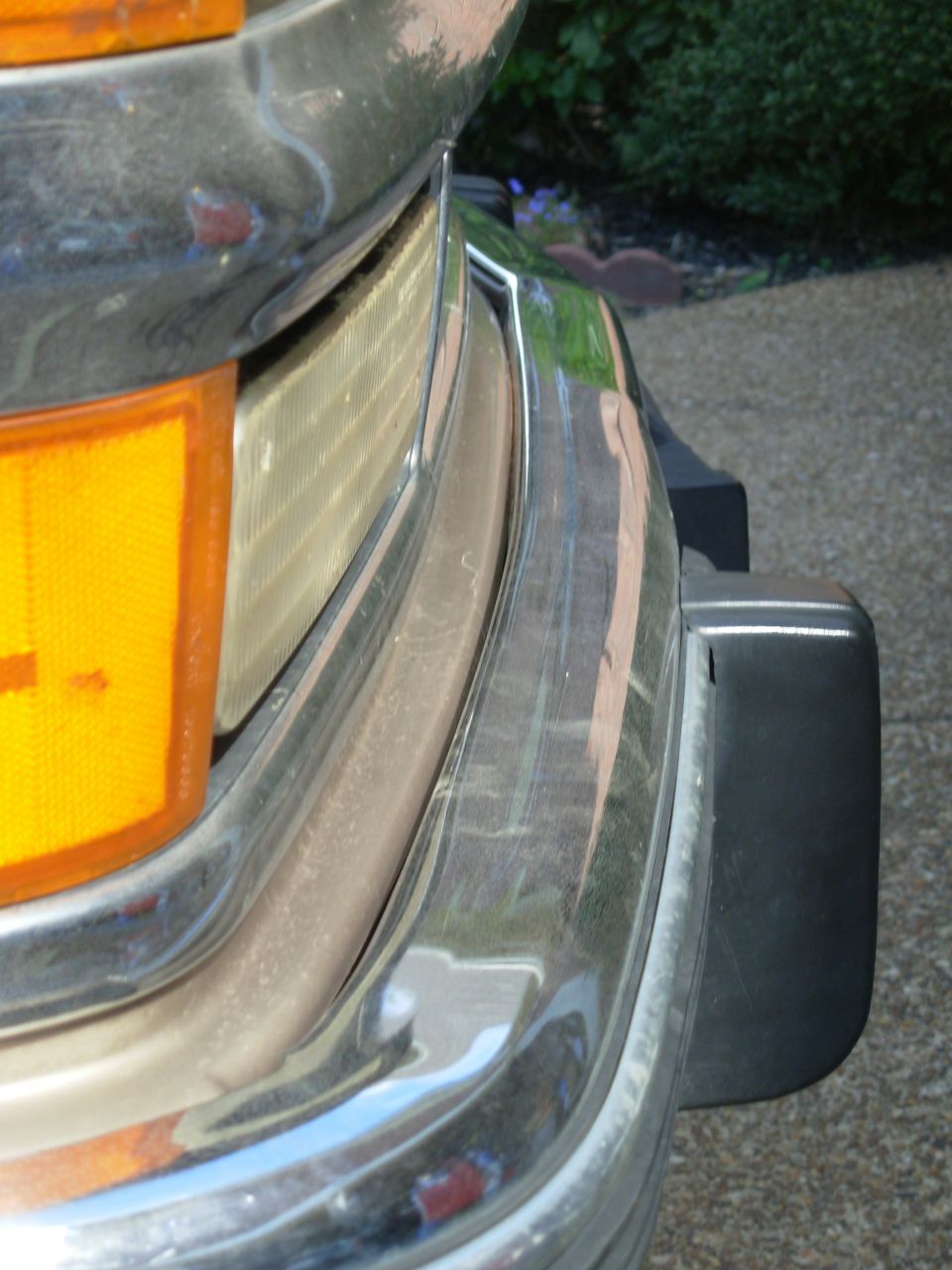 The front is bent the other way, and it's pinning the valance against the oil cooler.  Some rust is barely visible just this side of center where the bumper is pressed against the valance.