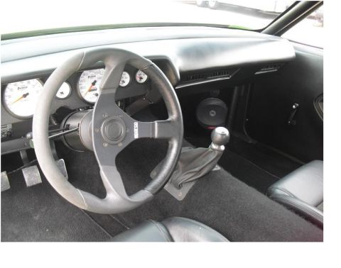 2007 Ford F-250 - The interior features a custom steering wheel, auxiliary gauges, and a manual transmission shifter, suggesting a performance-oriented build.