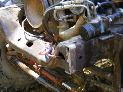 1978 Ford Bronco - Detail of vehicle frame and engine components, showing hydraulic lines and wiring.