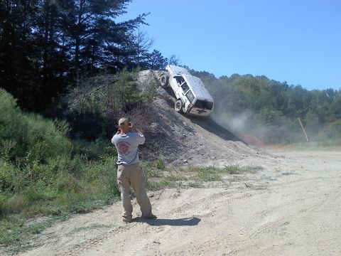 1989 Ford Bronco - Off-road vehicle attempts to ascend a challenging dirt incline.