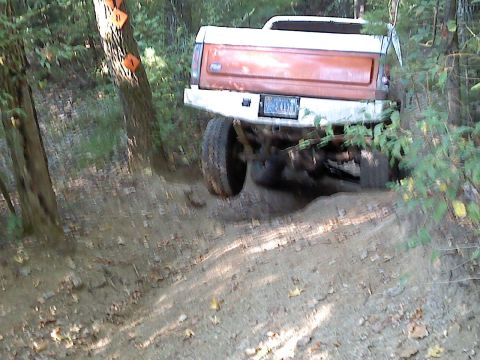 1989 Ford Bronco - A Ford Bronco navigates a challenging off-road trail.