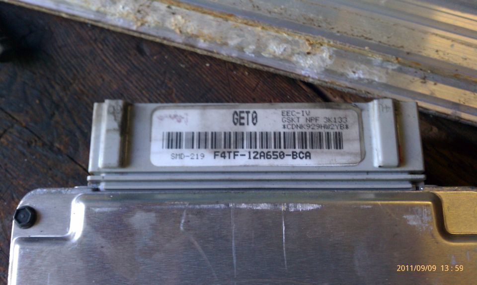 Close-up of an engine control module with a label showing GET8 and F4TF-12A650-BCA