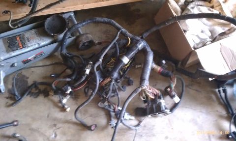 1992 Ford Bronco - Engine wiring harness spread out on the floor, showing numerous connectors and wire bundles.