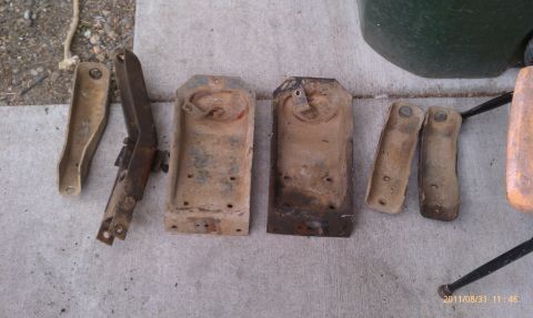 1992 Ford Bronco - Various used vehicle suspension components are displayed on a concrete surface.