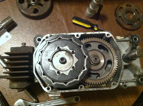 1981 Garelli Rally Sport - Close-up of a moped's internal engine components, including the clutch assembly and gears, laid out on a table.