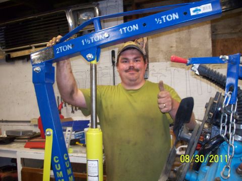 1990 Ford Bronco - A man gives a thumbs up next to a blue engine hoist in a workshop.