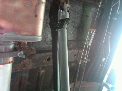 1979 Ford Bronco - Undercarriage view showing a driveshaft and associated mechanical parts, with visible rust.