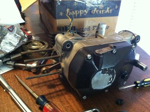 1981 Garelli Rally Sport - A disassembled motorcycle engine sits on a table, surrounded by tools and a box labeled 'happy drinks'.