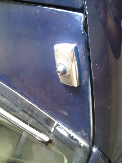 1994 Ford Bronco - A close-up view of a car's door lock cylinder and surrounding body panel.