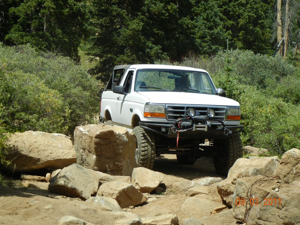 White 1996 Ford Bronco with winch on rocky terrain