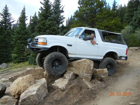1996 Ford Bronco - This 1996 Ford Bronco is navigating a rocky trail with a driver inside.