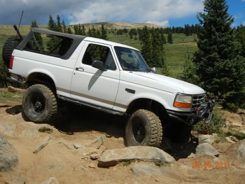 1996 Ford Bronco - This 1996 Ford Bronco is shown tackling a challenging off-road course on a sunny day.