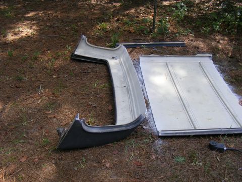 1978 Ford Bronco - A car hardtop and door panel are seen lying on the ground outdoors, with a Supermotors.net watermark visible.