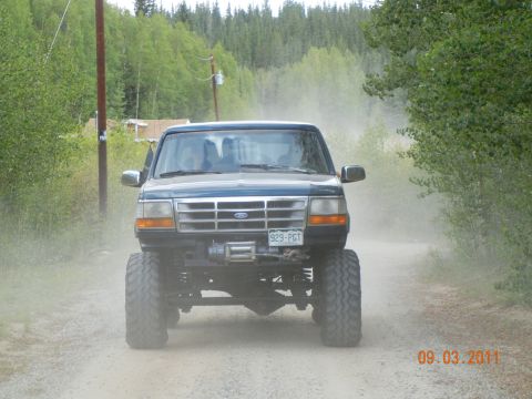 1996 Ford Bronco - This 1996 Ford Bronco is kicking up dust on a dirt road.