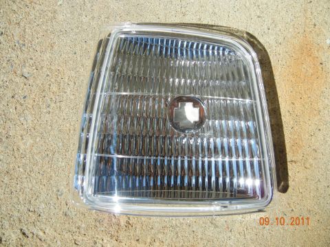 1996 Ford Bronco - Clear plastic turn signal assembly for a car, showing chrome reflector detail.