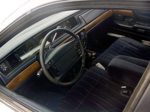 1999 Ford Crown Victoria - Interior view of a 1999 Ford Crown Victoria, showing the dashboard, steering wheel, and seats.