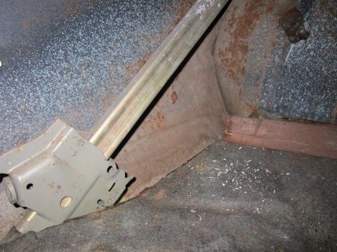 1991 Ford LTD Crown Victoria - Close-up of a car's interior showing a rusty panel and a mechanical component.