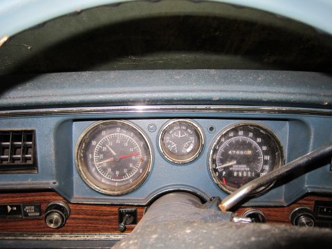 1991 Ford LTD Crown Victoria - The interior of a vehicle shows a dashboard with multiple gauges and wood trim details.