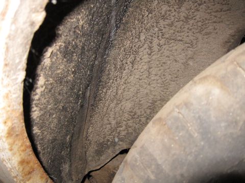 1991 Ford LTD Crown Victoria - The underside of a vehicle's wheel well shows accumulated dirt and a portion of the tire.