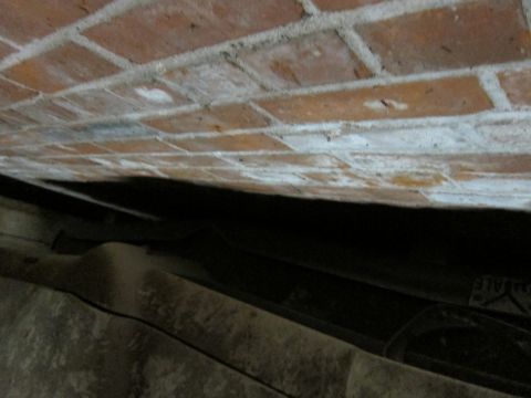 1991 Ford LTD Crown Victoria - A view looking up at a brick wall with a dark space below it.