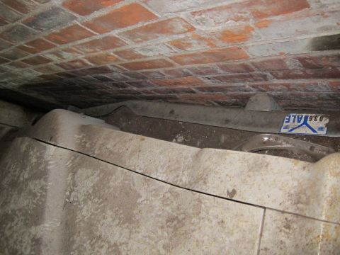 1991 Ford LTD Crown Victoria - A close-up view of a vehicle's fender and a brick ceiling, with a sticker visible on the fender.