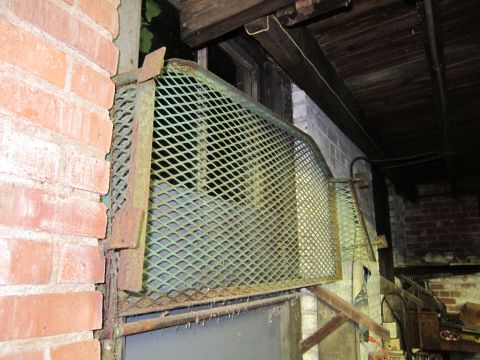 1991 Ford LTD Crown Victoria - A metal grate is installed over a doorway, showing signs of rust and wear.
