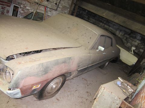 1991 Ford LTD Crown Victoria - This dusty sedan sits in a garage with another vehicle partially visible behind it.