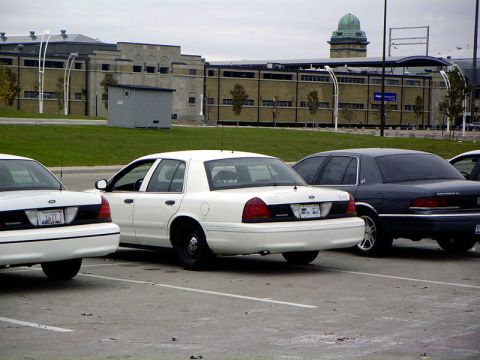 1999 Ford Crown Victoria - A white 1998 Ford Crown Victoria is seen parked in a lot with other vehicles.
