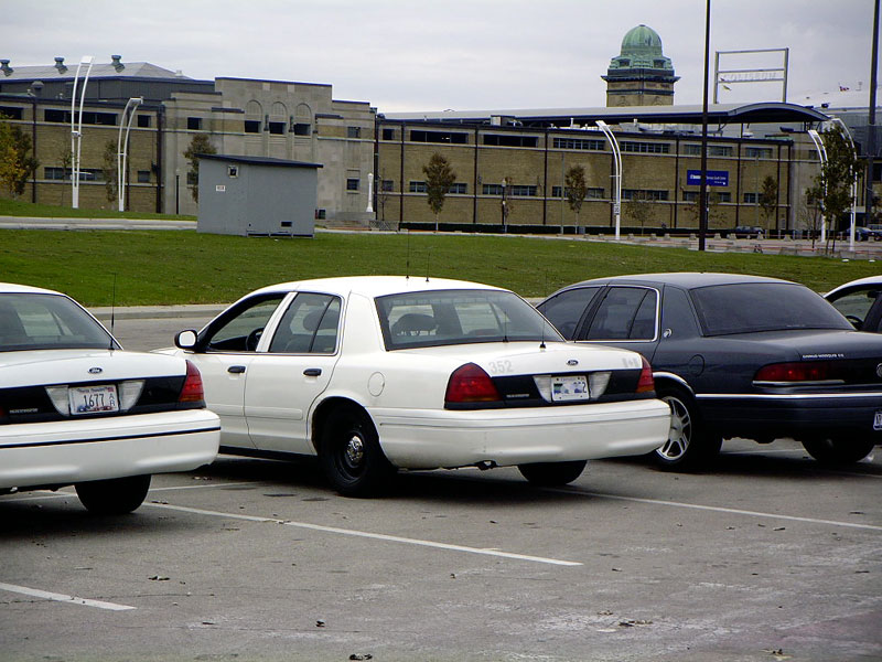 White 1998 Ford Crown Victoria parked next to a dark sedan