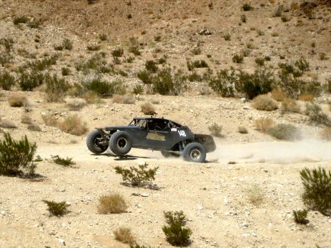 1996 Ford Bronco - Off-road buggy races through a dusty desert environment.
