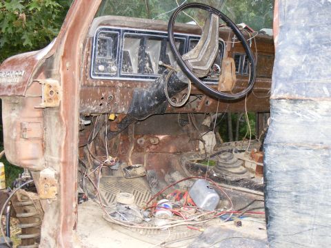 1978 Ford Bronco - The interior of a 1978 Ford Bronco shows significant rust and exposed wiring.