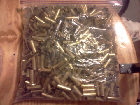 1996 Ford Bronco - Bag of spent shell casings on a wooden surface.