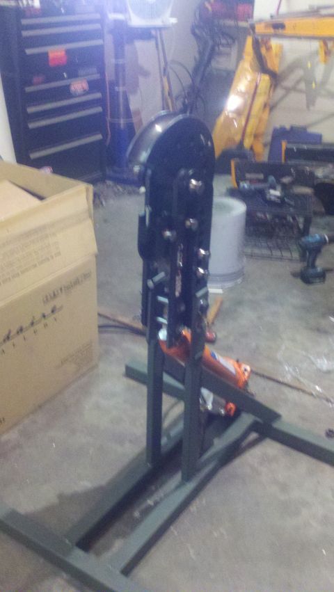 1988 Ford Bronco - A black metal fabrication tool, possibly a press or bender, is shown with an orange hydraulic jack at its base.