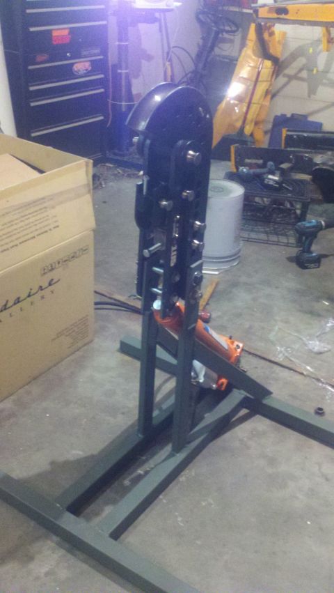 1988 Ford Bronco - A metal fabrication tool with an orange hydraulic jack is shown in a workshop setting.