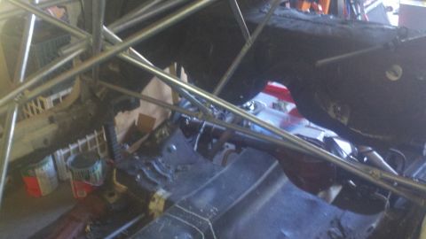 1978 Ford Mustang II - The underside of a car chassis is visible, a roll cage and rear axle, suggesting a project vehicle or race car build.