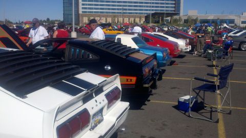 1978 Ford Mustang II - A line of cars at a show, with a black 1978 Ford Mustang II prominently featured in the foreground.